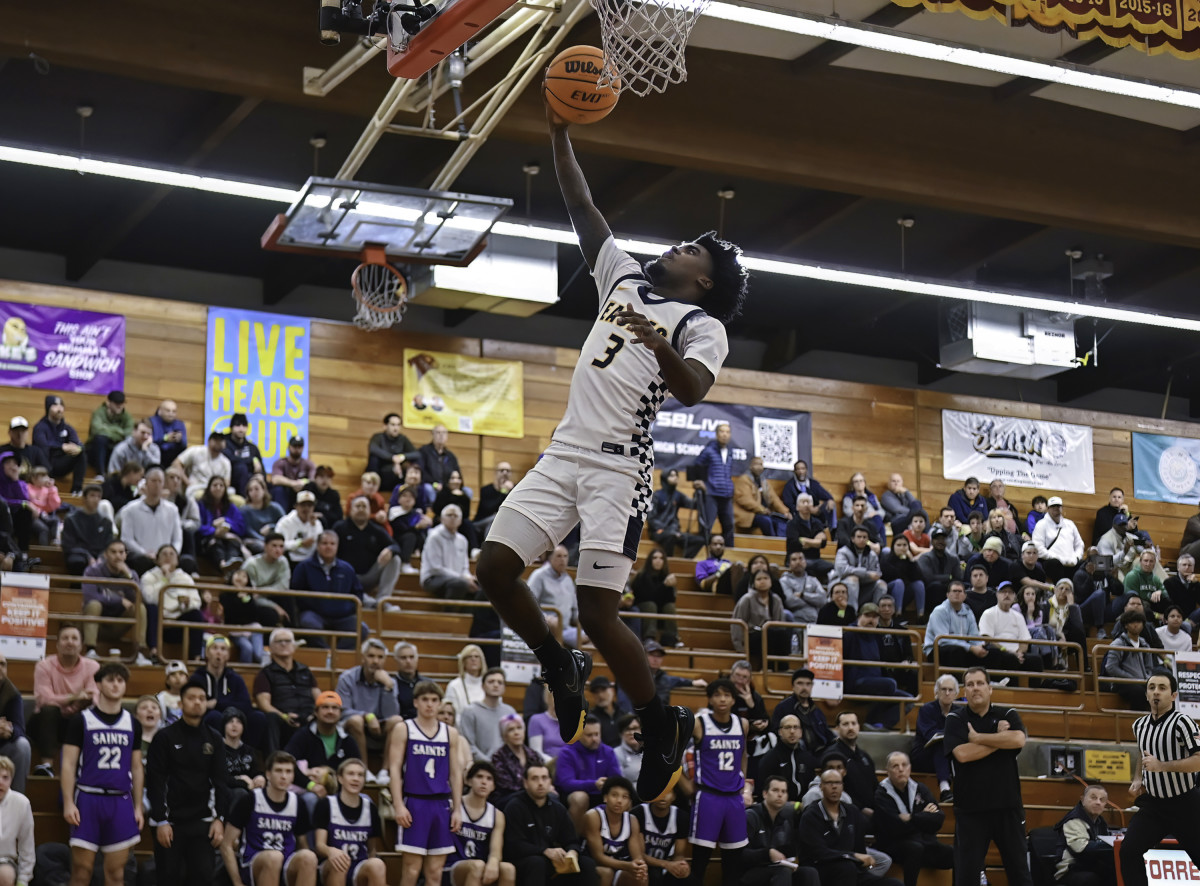Jazz Henderson (3) swoops in for another deuce. He finished with 14 points.